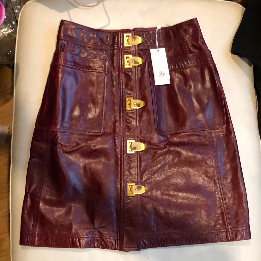 Tory Burch burgundy leather skirt with gold clasps on front